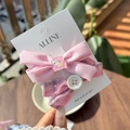 Detail of pink bow hair clips with cat illustration and plaid pattern on display card - Cream Pink - Dog Button Plaid Clip