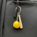 Mini yellow softball keychain with wooden bat accessory hanging on a black backpack - 2cm Ball + 4.5cm Bat / Yellow