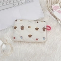 Detailed view of quilted makeup bag with teddy bear prints on a white plush background - Bread Doggy