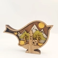 Detail of multi-layer carved wooden bird featuring intricate spring forest and mountain scenery - Bird