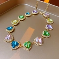 Close-up of colorful heart-shaped crystal necklace with gold plated chain links - Gold (Colorful Stone)