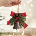 Vintage metal Christmas bell with red bow, pine cones, and berries held in hand - Coffee Berry Bell