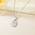 Close-up of silver tulip flower relief pendant on a delicate chain over silk fabric - Snake Chain-Steel Tulip
