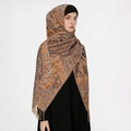 Close-up of brown paisley wool blend scarf with fringe details worn as a headscarf - Brown Paisley (T490-04)