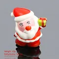 Santa Claus squishy toy with green gift box, 32g weight and 9x7cm size for Christmas - Santa Claus