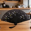 Classic black folding fan with floral patterns, butterflies, and a black silk tassel - Style 15 (New Style)