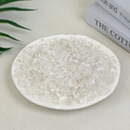 Irregular clear white crystal crushed stones for aromatherapy on a cream desk surface - 100g Of Clear White Crystal (7-9mm)