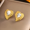 Macro shot of gold heart-shaped earrings with white marble stone inlay and textured edges - Gold White Turquoise E-244