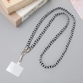 Black and white woven phone strap with silver metal clasp and card on decorative background - 10mm Width / Black