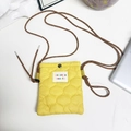 Detail of yellow quilted nylon mobile phone bag with wave stitching and logo patch - Yellow