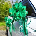 Close-up of a large green multi-layer ribbon bow for wedding car decoration outdoors - 10 Strands Pack / Matte Green