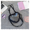 Black heart-shaped Ita bag with clear window, crossbody strap and laptop on grid background - Black