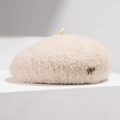 Detailed close-up of beige wool beret featuring a soft plush texture and bronze metal bow - Adjustable / Off-white