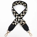 Close-up of ethnic style chevron woven bag strap with golden metal buckles and leather ends - Black Leaves