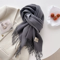 Flat lay of charcoal grey cashmere scarf with fringe details and woven label - Medium Grey