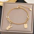 Detailed macro view of 18k gold bracelet with cute rabbit and engraved rectangle charms - Gold Rabbit Rectangular Tag Style (587)