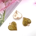Golden glitter heart pendants for DIY jewelry making shown in a minimalist setting - Yellow