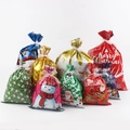 Detail of Christmas drawstring gift bags in multiple sizes with Santa and elk patterns - Red, Green, Gold, and Pink Style Set
