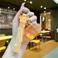 Close-up of Sakura themed keychain with orange dried flowers and silicone wrist strap - Cherry Blossom Rope [orange] Glow-in-the-dark Dried Flower Iceberg Cup