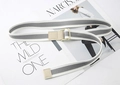 Detail of grey and white striped canvas belt with beige faux leather trim and metal buckle - Grey Center White Sides