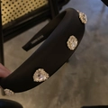 Close-up of black satin padded headband featuring large rhinestones and handmade mark - 6 Irregular Rhinestones / Black