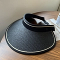 Black woven open top sun hat with wide brim and beige trim on a wooden table - Fine Edge L-Shape Straw Hat / Black