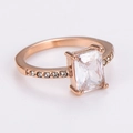 Detail of rose gold ring featuring a rectangular zircon stone and side-set accents - US 7 / Rose Gold/White Zirconia