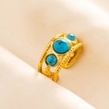 Detail view of gold adjustable ring featuring three blue stones and woven texture design - Gold-Dark Blue Stone