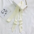 Elegant cream white skinny silk scarf tied on a white handbag handle as a stylish accessory - 200cm / Light Beige
