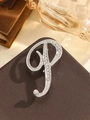 Elegant silver letter P brooch featuring sparkling rhinestones on a brown leather surface - Silver Letter P
