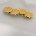 Elegant gold metal spring hair clip featuring a minimalist irregular textured cloud design - Gold Staggered Heart Clip