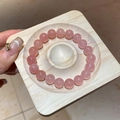 Macro detail of pink strawberry crystal beaded bracelet on a wooden display tray - 34# Bracelet (10mm/Box)