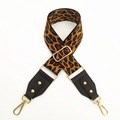 Close-up of adjustable leopard print canvas strap with gold swivel hooks and leather ends - Brown Leopard