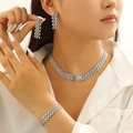 Three-piece silver link jewelry set featuring necklace, bracelet, and studs on a model - Silver Tone Earrings Bracelet And Necklace