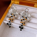 Detailed view of silver flower earrings with vintage black and amber beaded tassels - Silver Black Brown