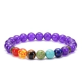 Macro detail of natural volcanic stone chakra bracelet with purple beads and metal spacers - Amethyst 7 Chakra