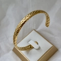 Polished 18K gold plated stainless steel cuff bracelet with braided texture on a stand - 8mm Wheat Pattern Open Bangle Gold