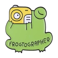 Cartoon green frog enamel pin holding a yellow camera with Frogtographer text - Frogtographer Style (xz7888)