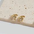 Chic gold flower stud earrings with central crystal stone on a beige stone base - Flower