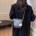 Blue denim and brown leather bucket bag with gold clasp and plush charm accessory - Blue with Pendant