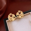 Close-up of 18k gold plated round stud earrings with cubic zirconia on jewelry box - Gold