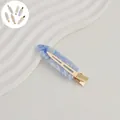 Close-up of a 7cm blue marble acetate hair clip with a sturdy gold metal spring - 108# Acetate 7cm Seamless Clip