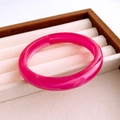 Macro detail of magenta resin acrylic bangle with unique white cloudy swirl texture patterns - Pink