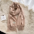 Soft beige cashmere blend scarf with elegant fringe trim on a plush carpet background - Melange Beige
