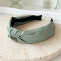 Minimalist knotted fabric headband in sage green color with textured twill finish - Green