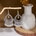 Detailed view of vintage silver hollow tassel earrings hanging on a decorative branch - E2874-23/Spherical Tassel