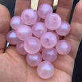 Macro shot of shimmering pink luminous beads for DIY jewelry and hair accessories - 16mm / Pink
