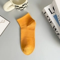 Orange low-cut mesh cotton sock with ribbed texture for men, shown on grey surface - One Size / Yellow