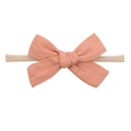 Detail of peach pink textured fabric bow on a soft nude nylon infant headband - Peach Pink (12)