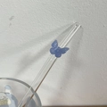 Transparent glass straw featuring a blue butterfly decorative accent on the upper part - Blue Jade